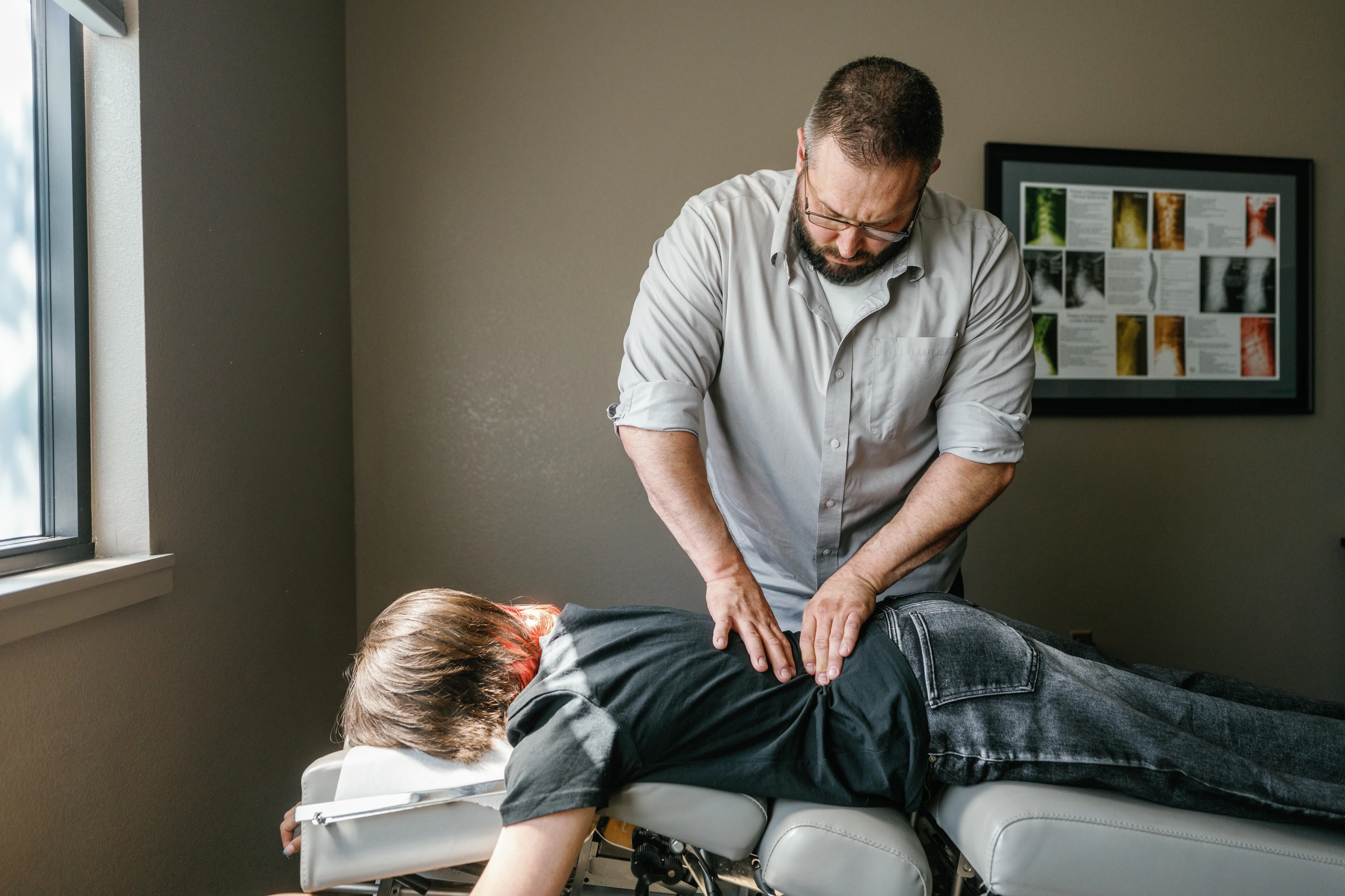 Chiropractor speaking with patient